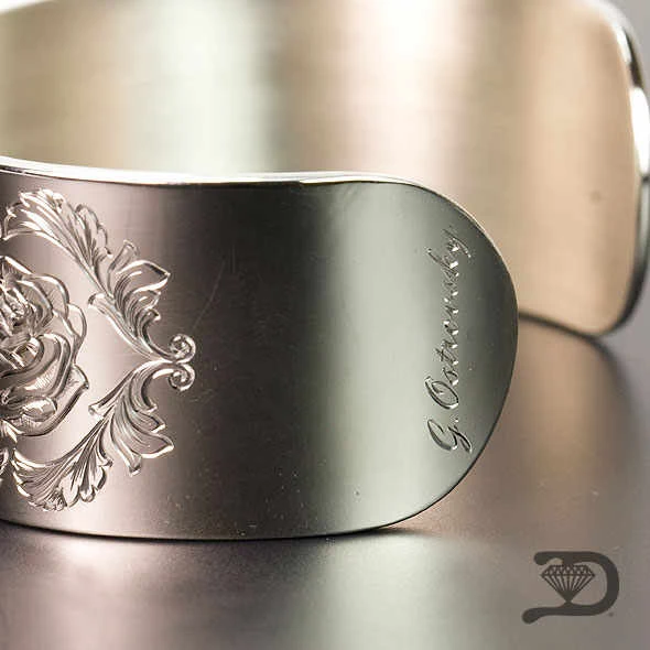 Detailed hand engraving on a silver cuff